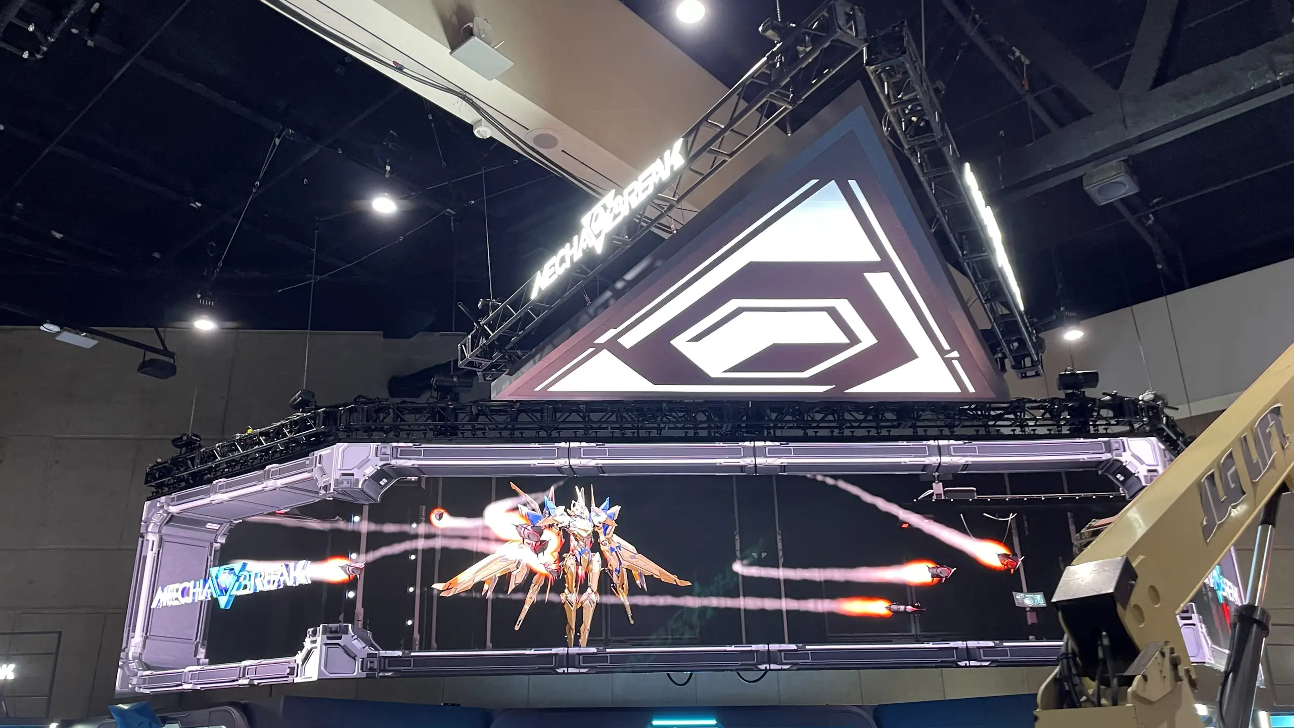 A flown LED wall, folded around a truss, over the show floor at San Diego Comic-Con 2025