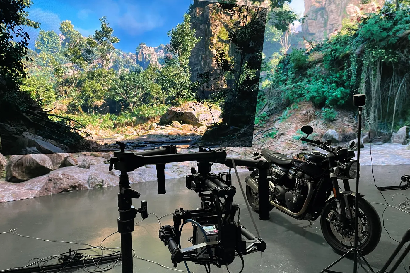 The bike stays still; move the background and on camera it is riding