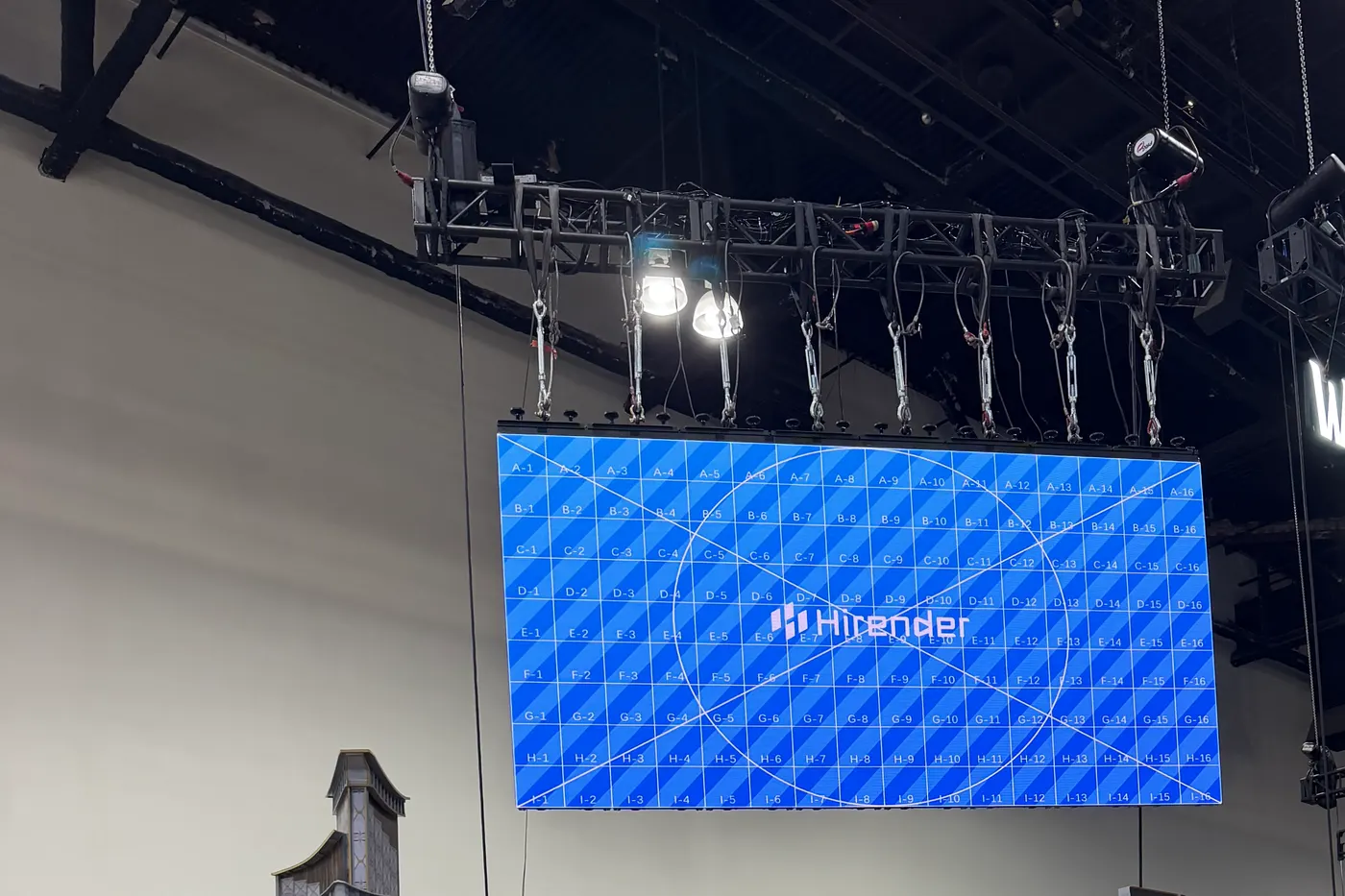 July 1, 2026: a flown wall lit over its booth