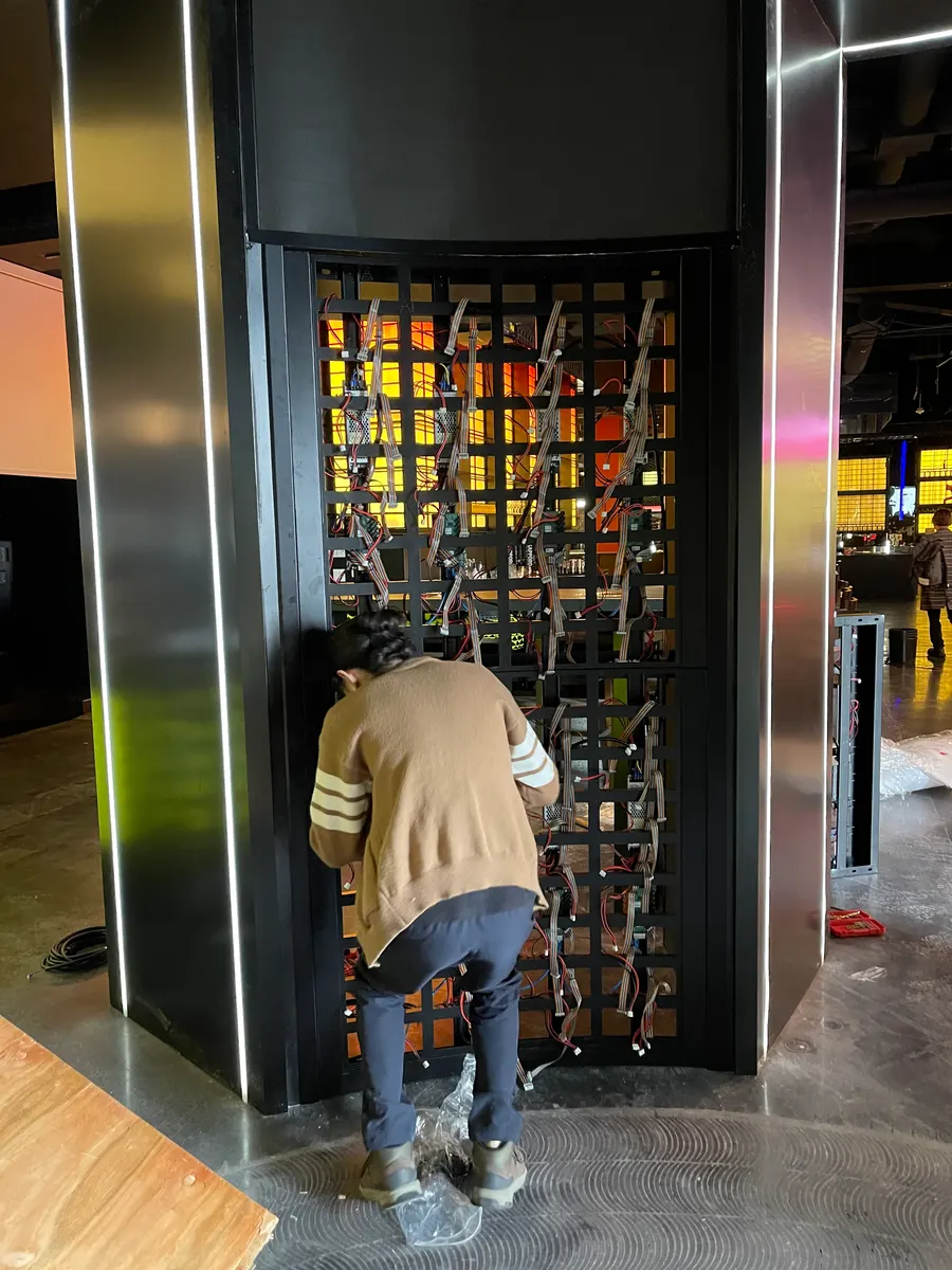 An entrance column: the curved frame cabled, before the modules
