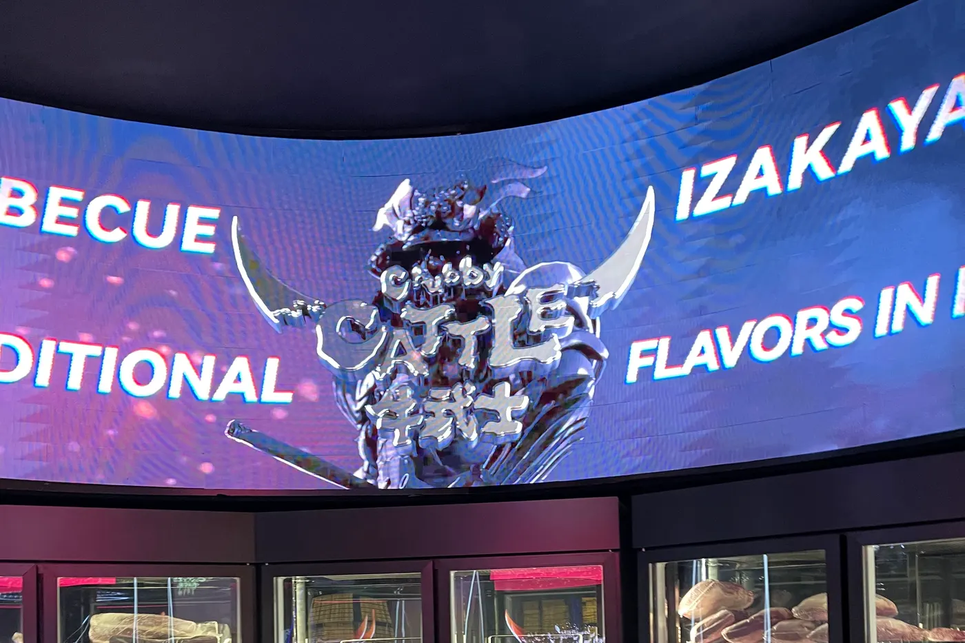 The curved band over the meat display, March 2024