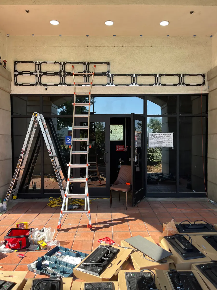 July 2025: the frame over the entrance, cabinets ready on the floor