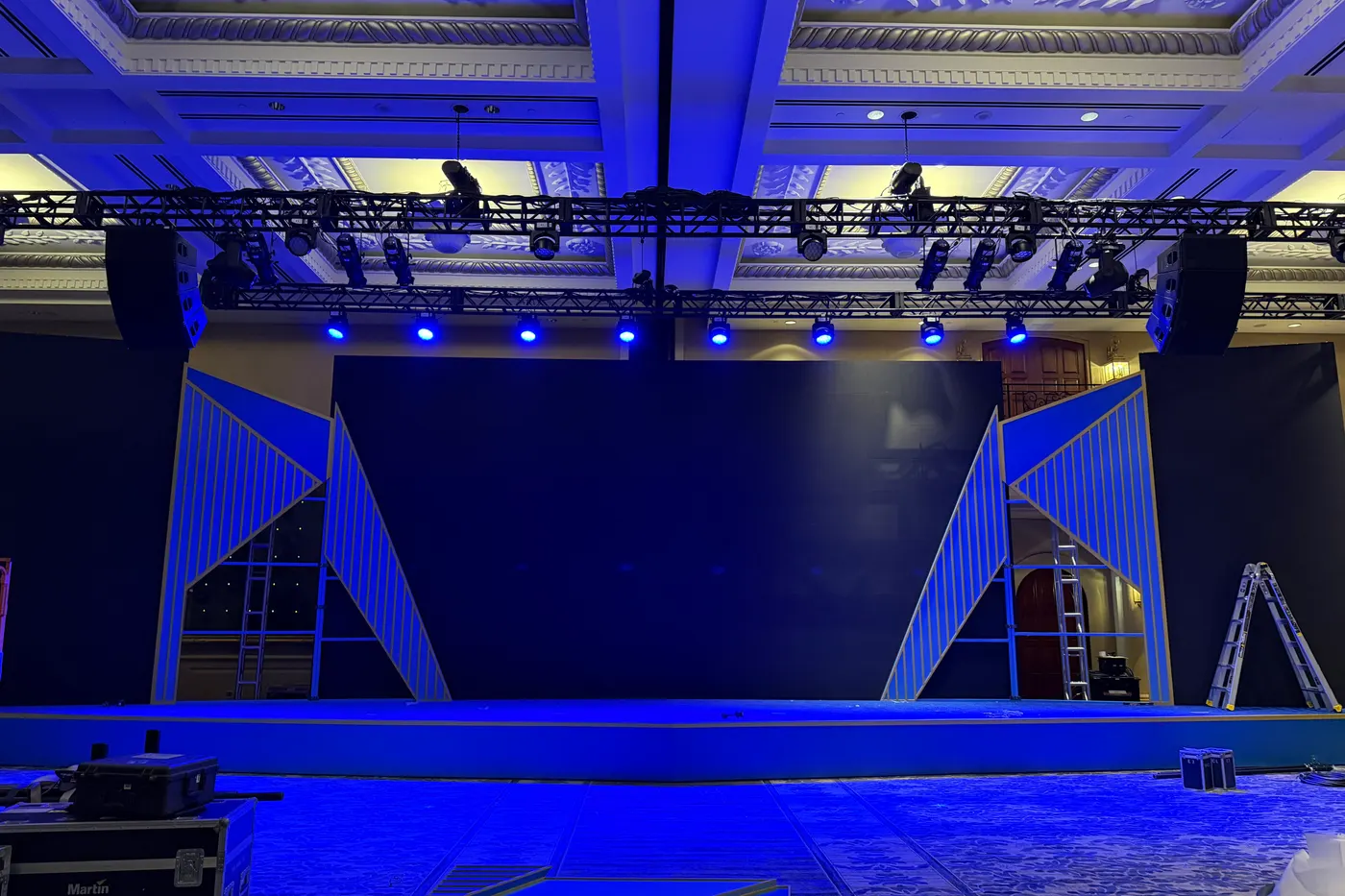 October 11, evening: the angled scenic panels set against the screens