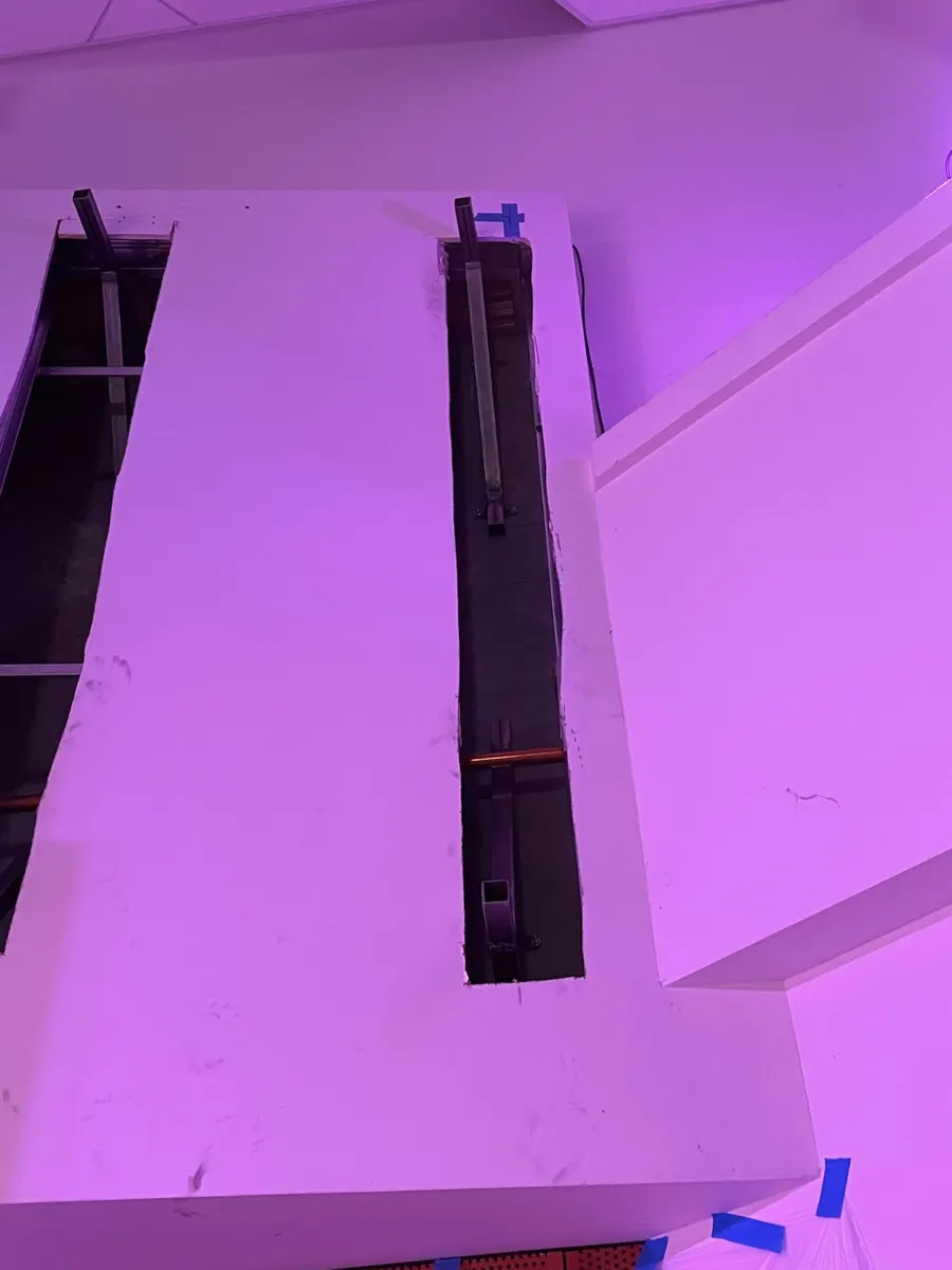 Irvine: steel brackets pass through the drywall to the concrete wall behind