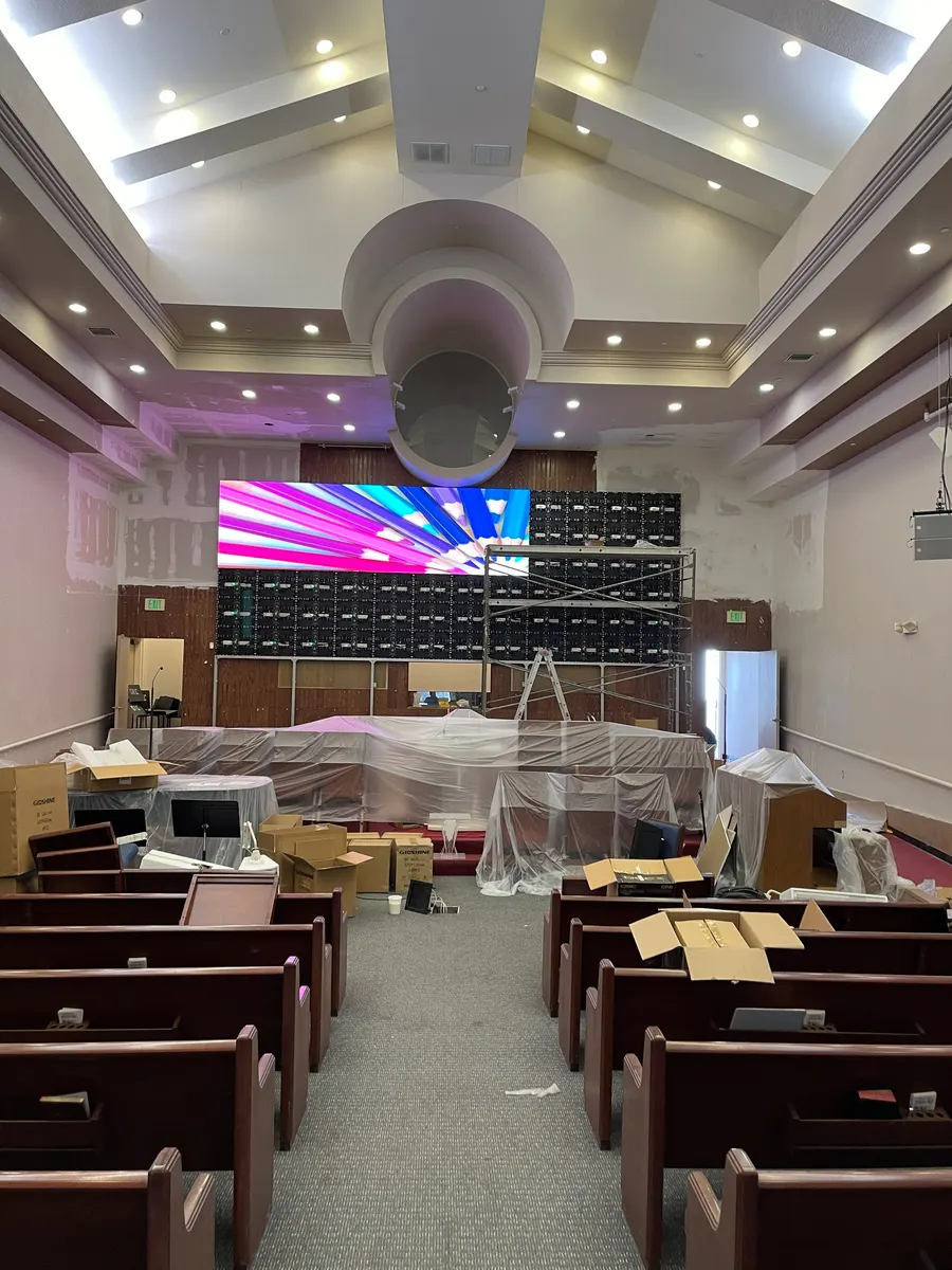 Cabinets going up with the stage and pews under sheeting, 31 May 2024