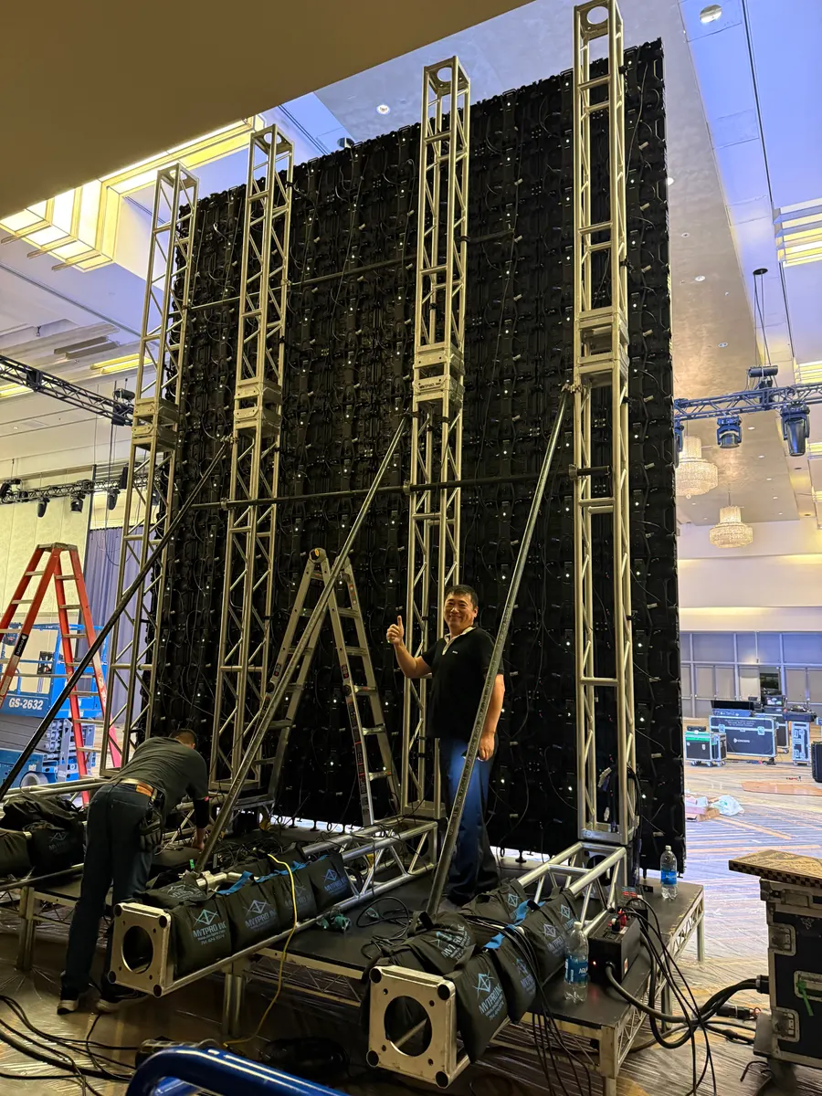 Behind the finished wall: towers, ballast and braces. Peter Lin on site
